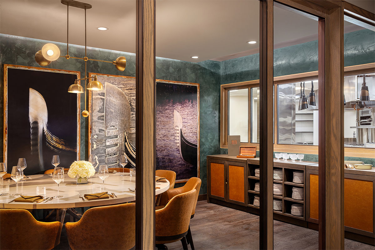 Elegant private dining room at La Zozzona with modern lighting and large gondola-themed artwork.